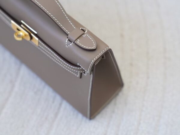 mmexport1732865844929 Women’s Clutch Bag CC18 Etoupe Swift Leather Kelly Pochette 22CM Gold Hardware