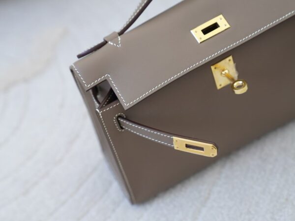 mmexport1732865846882 Women’s Clutch Bag CC18 Etoupe Swift Leather Kelly Pochette 22CM Gold Hardware