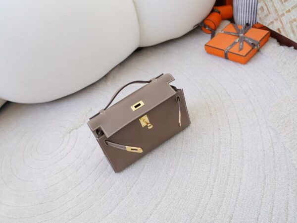 mmexport1732865853266 Women’s Clutch Bag CC18 Etoupe Swift Leather Kelly Pochette 22CM Gold Hardware